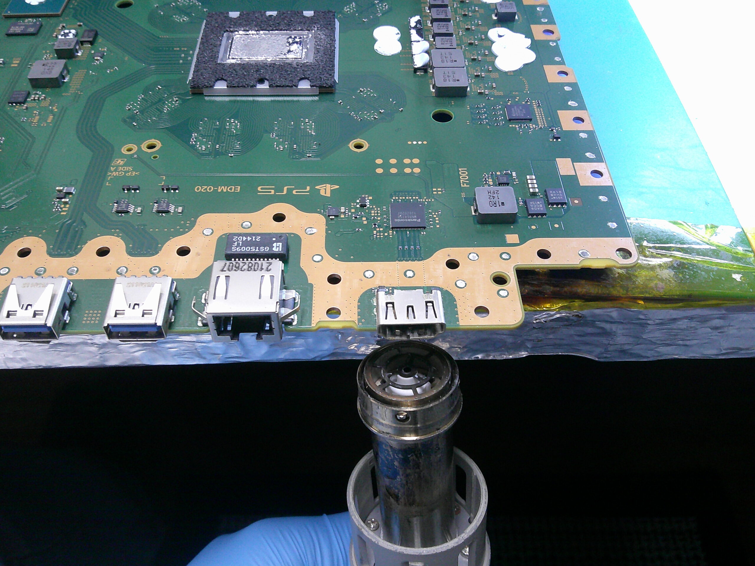 PS5 motherboard undergoing HDMI repair at Replay ElectronX