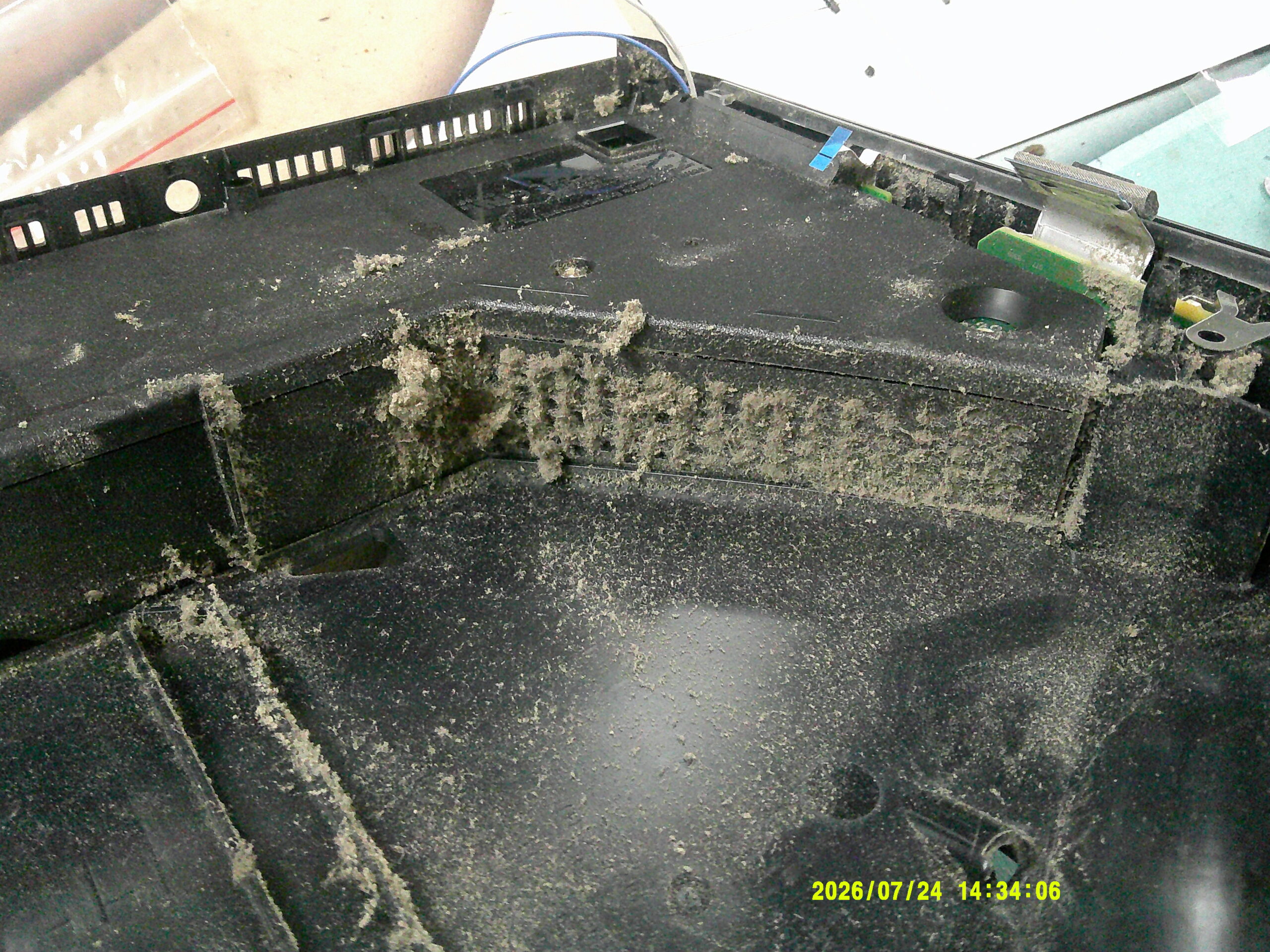 Heavy dust and debris inside a game console before internal cleaning at Replay ElectronX